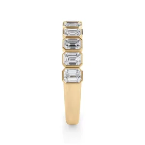 Emerald-cut lab diamonds, framed in bezels, enhance this half-eternity band with timeless elegance.