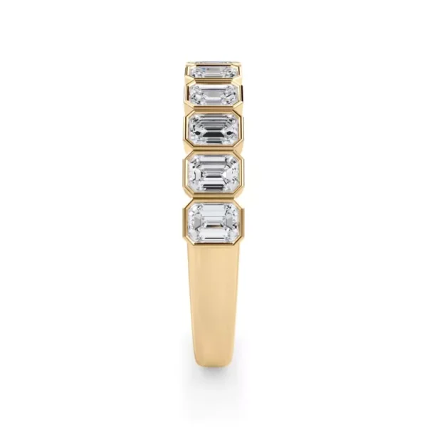 Emerald-cut lab diamonds, framed in bezels, enhance this half-eternity band with timeless elegance.