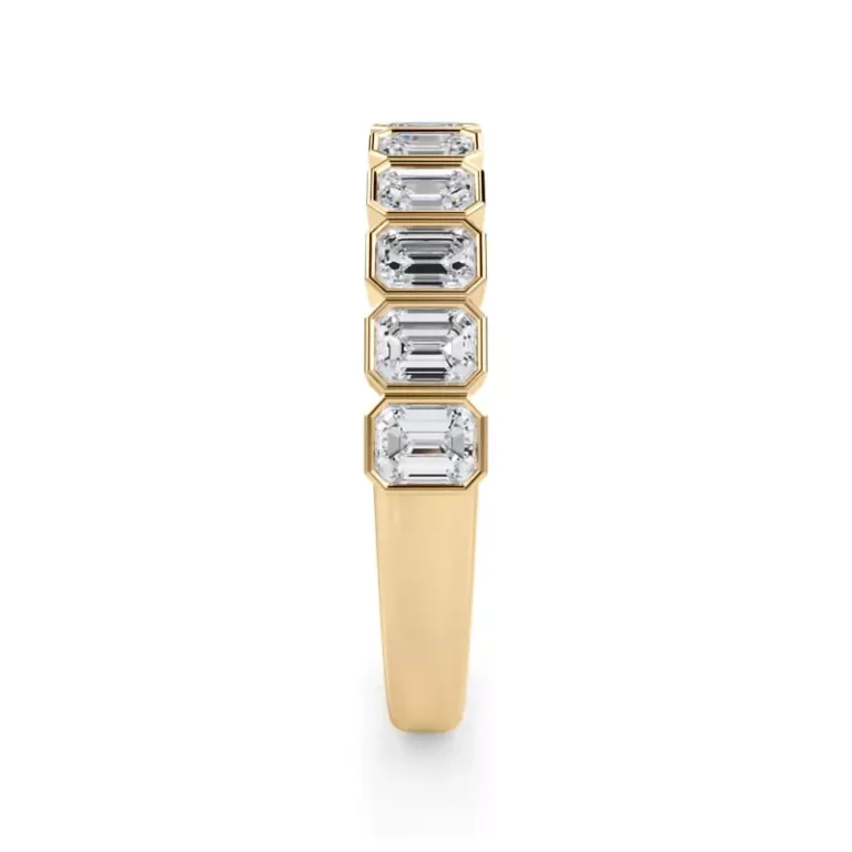 Emerald-cut lab diamonds, framed in bezels, enhance this half-eternity band with timeless elegance.