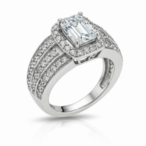 Men's white gold band, with the top part of the ring facing towards the upper left corner of the frame. The central element is a clear, emerald-cut gemstone, held in place by four prongs. Surrounding this central stone is a halo of smaller, clear, round gemstones. The band of the ring is wide and also heavily adorned with rows of small, clear, round gemstones, set closely together to create a sparkling effect. 