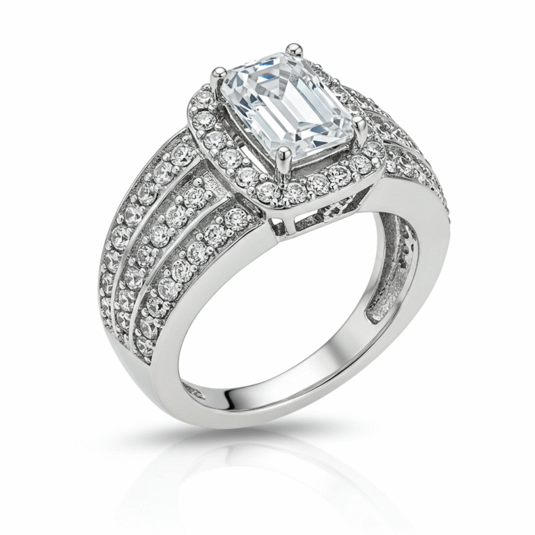 Men's white gold band, with the top part of the ring facing towards the upper left corner of the frame. The central element is a clear, emerald-cut gemstone, held in place by four prongs. Surrounding this central stone is a halo of smaller, clear, round gemstones. The band of the ring is wide and also heavily adorned with rows of small, clear, round gemstones, set closely together to create a sparkling effect. 
